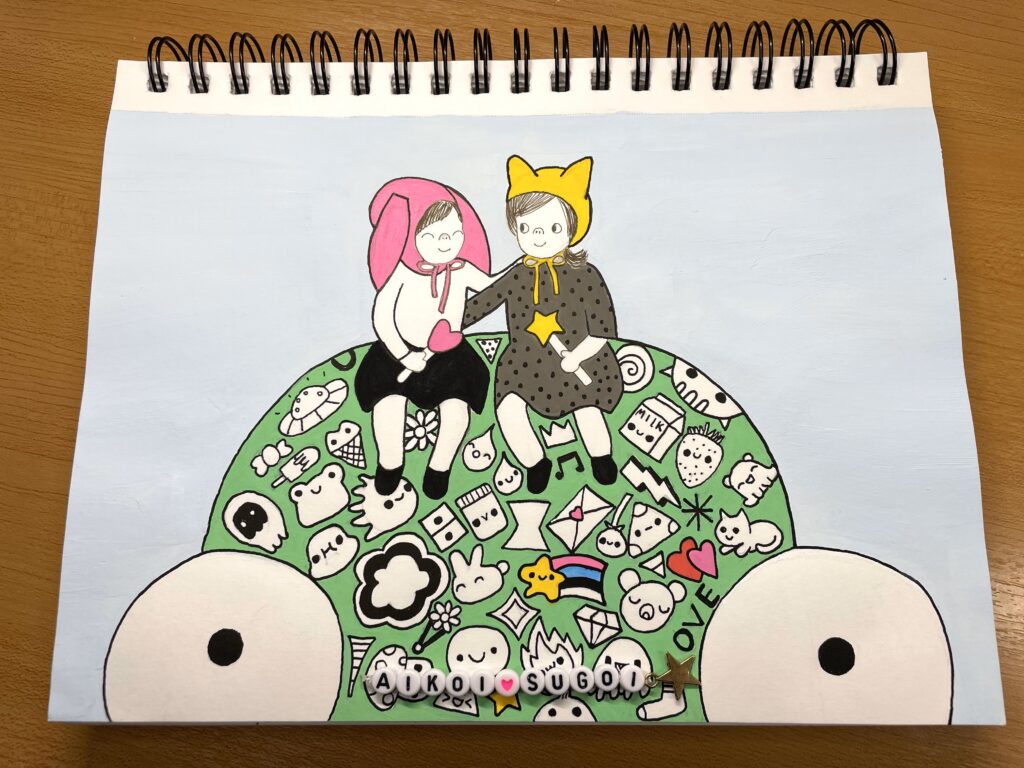 girls sitting on head of a giant green monster