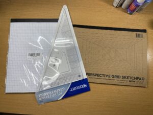 drawing tools featuring grid paper and a triangular ruler