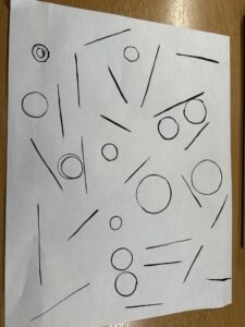 lines and circle on a paper in black paint